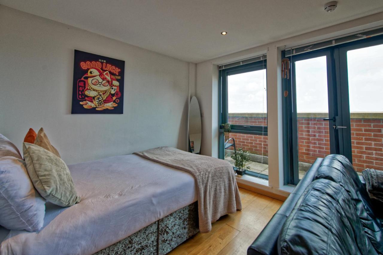 A bedroom with a bed and window at the Liverpool city centre apartment