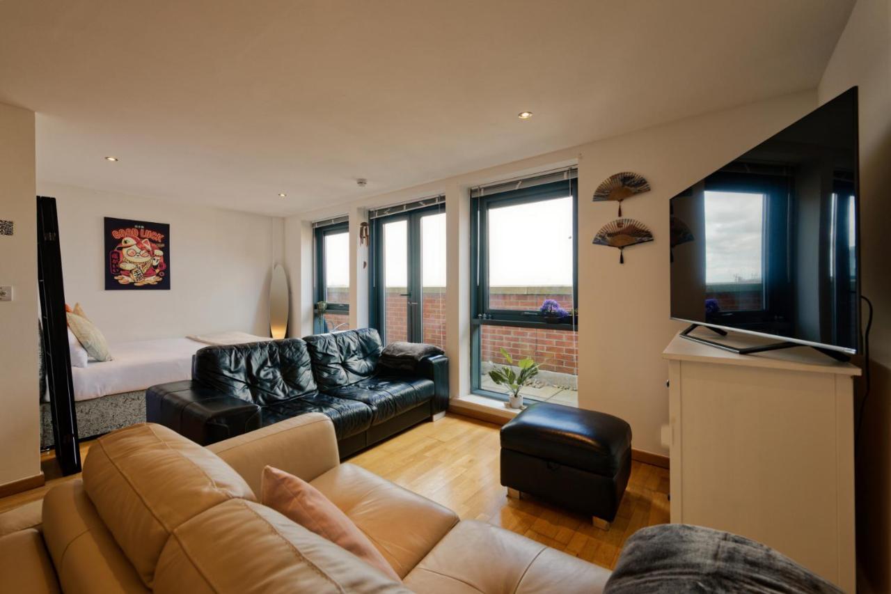 A living room with a sofa and television in the apartment