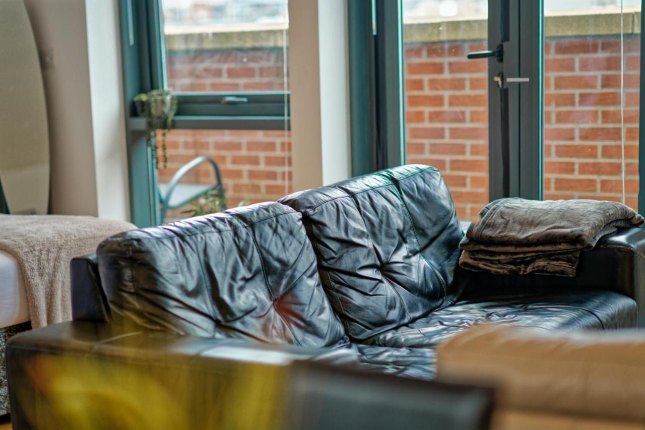 A black leather sofa in the apartment living room